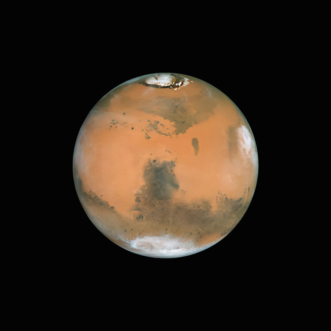Photo by NASA Hubble Space Telescope a red planet with a black background